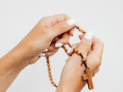 Details of hands in a prayer position during meditation.